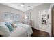 Bedroom featuring a bed with plush pillows, a dresser, and a window at 5501 E Longboat Blvd, Tampa, FL 33615