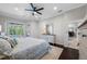 Cozy Primary bedroom with lanai access, ceiling fan, and dark hardwood flooring at 5501 E Longboat Blvd, Tampa, FL 33615