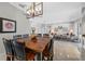 Elegant dining room with modern light fixture and seamless access to living room area at 5501 E Longboat Blvd, Tampa, FL 33615