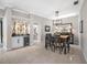 Elegant dining room featuring a wet bar with wine fridge and modern lighting fixtures at 5501 E Longboat Blvd, Tampa, FL 33615