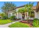 Charming home featuring a tile roof, tropical landscaping, and a welcoming front entrance at 5501 E Longboat Blvd, Tampa, FL 33615