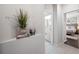 Inviting hallway leading to the bathroom and bedroom with warm tile flooring at 5501 E Longboat Blvd, Tampa, FL 33615