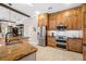 Modern kitchen with stainless steel appliances and custom wood cabinets with marble backsplash at 5501 E Longboat Blvd, Tampa, FL 33615