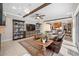 Open living area with wood beams, tile flooring, and view to kitchen at 5501 E Longboat Blvd, Tampa, FL 33615