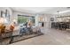 Open concept living room with tile floors, bar, dining area, and access to the pool at 5501 E Longboat Blvd, Tampa, FL 33615