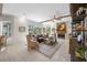 Bright living room features beamed ceiling, tile floor, and fireplace at 5501 E Longboat Blvd, Tampa, FL 33615