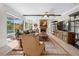 Beautifully staged living room with view to pool, stylish furnishings, and tile floors at 5501 E Longboat Blvd, Tampa, FL 33615