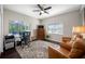 Bright home office with a large window, ceiling fan, and comfortable seating area at 5501 E Longboat Blvd, Tampa, FL 33615