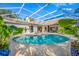 Beautiful pool area with travertine tile and a panoramic screen enclosure at 5501 E Longboat Blvd, Tampa, FL 33615