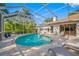 Sparkling pool surrounded by lush tropical landscaping and a full screen enclosure at 5501 E Longboat Blvd, Tampa, FL 33615