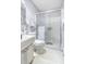 Neat bathroom featuring a glass-enclosed shower, toilet, and a vanity with ample storage at 5603 80Th N St # 512, St Petersburg, FL 33709