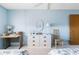 This bedroom features twin beds, desk and a dresser at 5603 80Th N St # 512, St Petersburg, FL 33709