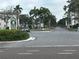 A view of the Five Towns community entrance sign, with mature landscaping and palm trees lining the street at 5603 80Th N St # 512, St Petersburg, FL 33709