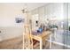 This dining room has a light wood dining table and a mirrored wall at 5603 80Th N St # 512, St Petersburg, FL 33709