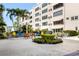 Expansive exterior view showcasing the building's outdoor communal space with seating, grill, and lush greenery at 5603 80Th N St # 512, St Petersburg, FL 33709