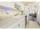 Bright kitchen featuring a sink, dishwasher, and pass-through to a cozy living space at 5603 80Th N St # 512, St Petersburg, FL 33709