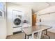 Clean and functional laundry room with a folding table, chairs, and coin-operated machines at 5603 80Th N St # 512, St Petersburg, FL 33709