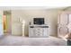 Living room featuring a media console, large lamp, and flatscreen television at 5603 80Th N St # 512, St Petersburg, FL 33709