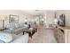 Open concept living room with mirrored wall, couch, and dining area at 5603 80Th N St # 512, St Petersburg, FL 33709