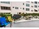 Outdoor patio area with chairs, tables, covered grill, and lush landscaping creating a welcoming communal space at 5603 80Th N St # 512, St Petersburg, FL 33709
