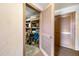 Convenient storage room featuring shelving, stored items, and an open door with 