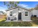 Exterior view of a gray painted home with a private fire pit area at 5802 N Suwanee Ave, Tampa, FL 33604