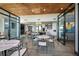 Spacious common area with tables, chairs, a modern kitchen and living space to create a functional and stylish atmosphere at 6218 Timberdale Ave, Wesley Chapel, FL 33545