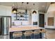 Modern kitchen featuring a large island with seating, stainless steel appliances, and open shelving at 6218 Timberdale Ave, Wesley Chapel, FL 33545