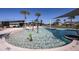 Fun splash zone with water features, surrounded by sun loungers, shade structures and palm trees perfect for families at 6218 Timberdale Ave, Wesley Chapel, FL 33545