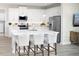 Modern kitchen with white cabinets, island, and stainless steel appliances at 6238 Timberdale Ave, Wesley Chapel, FL 33545