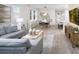 Spacious living room with gray sectional sofa and large TV at 6238 Timberdale Ave, Wesley Chapel, FL 33545
