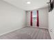Cozy bedroom featuring a window with red curtains and plush carpeting at 7055 Summer Holly Pl, Riverview, FL 33578
