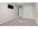 Simple, neutral bedroom with a double closet, carpet and a television at 7055 Summer Holly Pl, Riverview, FL 33578