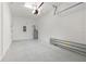 Clean garage with white walls, speckled floor and a garage door with opener at 7055 Summer Holly Pl, Riverview, FL 33578