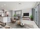 Inviting living room featuring an entertainment center, dining area, neutral color palette, and sliding doors to the exterior at 7055 Summer Holly Pl, Riverview, FL 33578