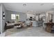 Bright and airy living room with open concept design that includes an adjacent kitchen, dining area, and comfortable seating at 7055 Summer Holly Pl, Riverview, FL 33578