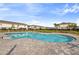 Community pool with clear blue water surrounded by palm trees and manicured landscaping at 7055 Summer Holly Pl, Riverview, FL 33578