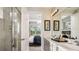 A modern bathroom features dual sinks, a large mirror, modern lighting, and a glass-enclosed shower at 750 Steel Dr, Apollo Beach, FL 33572