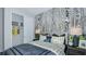 A charming bedroom with a birch tree mural, a comfortable bed, a large closet, and neutral decor at 750 Steel Dr, Apollo Beach, FL 33572
