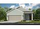 Charming single-Gathering home featuring a two-car garage, neutral colors, and professionally landscaped front yard at 750 Steel Dr, Apollo Beach, FL 33572