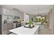 A modern eat-in kitchen features stainless steel appliances, stylish gray cabinetry, and an island at 750 Steel Dr, Apollo Beach, FL 33572