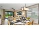 Open-concept living space featuring modern decor, dining area, and sliding glass doors to a patio with a pool at 750 Steel Dr, Apollo Beach, FL 33572