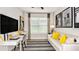 A stylish office with a modern desk, a comfortable sofa, neutral colors, and wood-look floors at 750 Steel Dr, Apollo Beach, FL 33572