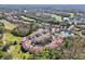 Aerial view of condo complex featuring well-maintained landscaping, ponds, and surrounding golf course and trees at 7532 Marsh Orchid Cir # 8-201, Bradenton, FL 34203