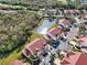 Beautiful aerial view of condo complex near a pond, surrounded by lush greenery and mature trees at 7532 Marsh Orchid Cir # 8-201, Bradenton, FL 34203