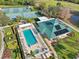 Aerial view of community amenities including pool, spa, tennis courts, clubhouse, and beautiful landscaping at 7532 Marsh Orchid Cir # 8-201, Bradenton, FL 34203