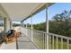Large balcony overlooking a wooded area and a golf course in the distance at 7532 Marsh Orchid Cir # 8-201, Bradenton, FL 34203