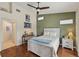 Well-lit bedroom with hardwood floors, a green accent wall, decor, and natural light at 7532 Marsh Orchid Cir # 8-201, Bradenton, FL 34203