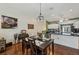 Dining area open to the kitchen with hardwood floors and abundant natural light at 7532 Marsh Orchid Cir # 8-201, Bradenton, FL 34203