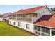 Exterior view of a two-story home featuring a screened-in porch and balcony with red tile roof at 7532 Marsh Orchid Cir # 8-201, Bradenton, FL 34203